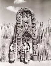 Women beneath a Maori arch