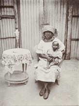 Portrait of a seated Nigerian woman and baby