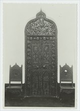 Carved doorway and two chairs