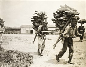 Korean labourers transporting firewood