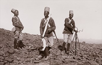 Three men with signaling equipment on the battle field at Omdurman