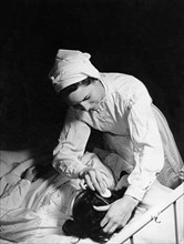 Nurse Tending To A Patient