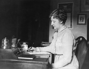 Woman Writing At Her Desk