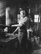 A Blacksmith At His Forge