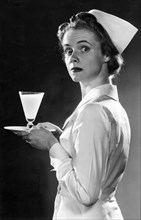 Nurse Carrying A Glass Of Milk