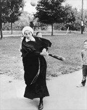 Nun Swinging A Baseball Bat