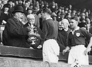 King Presents Soccer Trophy