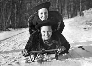 Two Young Women On A Sled