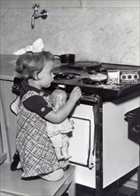 Girl And Doll In Kitchen