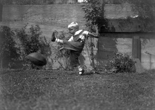 A Small Boy Kicking Football