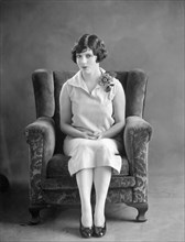 Woman Sitting In A Chair