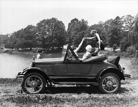 A Woman Exiting A Rumble Seat