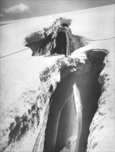 Climber Crossing An Ice Bridge