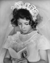 Girl Reading A Prayer Book