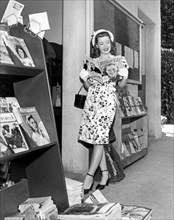 A Woman At A Magazine Stand