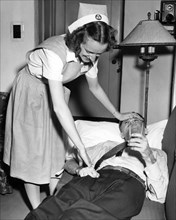 Red Cross Nurse With Patient