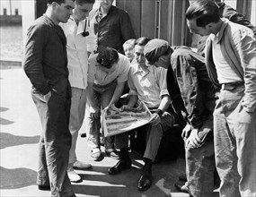 Men Looking At A Newspaper