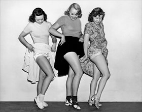 Three Women Lift Their Skirts
