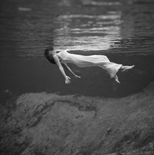 Weeki Wachee, Florida:  1947.
An underwater fashion photograph of a woman, wearing a long gown,