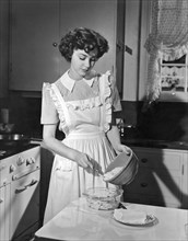 Hollywood, California:  1942.
Actress Marsha Hunt prepares apple cobbler in her kitchen. She was