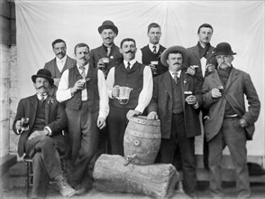 Men Around A Keg Of Beer