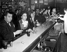 New York, New York:  c. 1945.
A crowded and smokey bar scene in the WWII era.