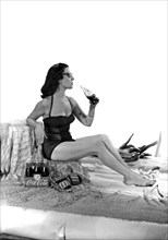 United States: c. 1947.
A set for a photo shoot for a Coca Cola ad, complete with beach sand and a