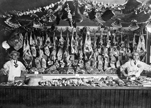 United States:  December 17, 1915.
Two butchers proudly display their products.