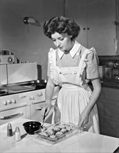 Hollywood, California:  1942.
Actress Marsha Hunt prepares summer squash in her kitchen. She was