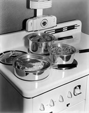 Beaver Dam, Wisconsin: c.1940.
A meal being cooked on the top of a Monarch Electric Stove, with