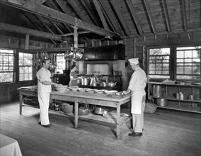 United States:  c. 1924.
The cooks and staff at a Girl Scout camp preparing dinner for the girls.
