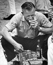 Spartanburg, South Carolina:  c. 1961.
Race car driver Cotton Owens refuels on canned pork &