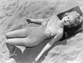 Woman Sun Bathing At The Beach