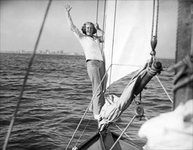 Woman On Bow Sprit Of Sailboat