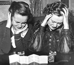 Detroit, Michigan:  January 30, 1934.
Two women apply their thinking power to the new fad, the Imp