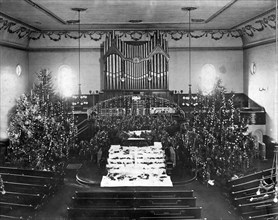 The interior of a church decorated for Christmas.