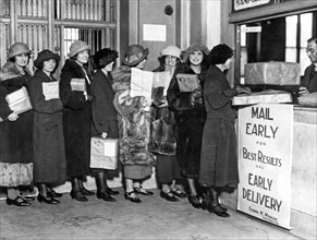 A line of women at the post office mailing their Christmas packa