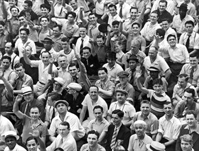 Happy baseball fans in the bleachers at Yankee Stadium.