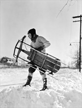 A Boy Carrying His Sled