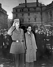 Rennes, France:  August 21, 1944.
General Charles de Gaulle salutes in the town square of Rennes,
