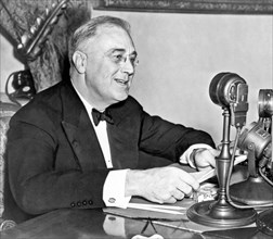 Washington, D.C.:  1937.
President Franklin D. Roosevelt, seated behind microphone, during one of