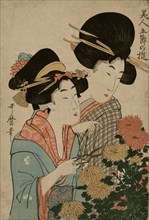 Two woman cut Chrysanthemums