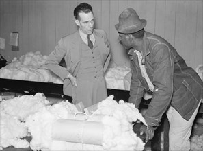 Black farmer who has brought his cotton samples to town discusses price with cotton buyer. 1939