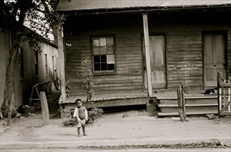 Black child in front of badly rundown house, Natchez, Mississippi 1935