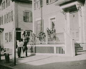 Exterior of Sprague House Settlement Providence, on Saturday morning. The house was so full that these children could not go in.  1912