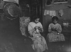 Katie (13 years) and Angeline Avella (11 years),  making cuffs, Irish lace.  1912