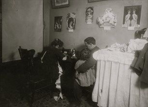 Italian woman sits at her Singer Sewing Machine making clothes for dolls  1911