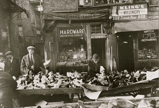 People shopping for shoes at shop on Maxwell Street, Chicago, Illinois 1941