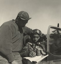 Pilot from the 332nd Fighter Group signing Form One Book 1945