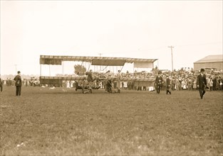 Harmon in aeroplane with crowds of onlookers